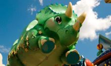 Tricera Top Spin ride flys high above the crowd inside Disney’s Animal Kingdom theme park.